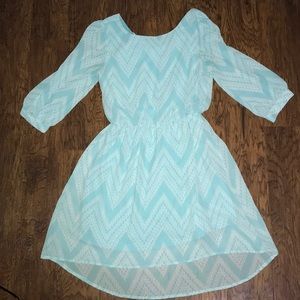 light blue/teal dress with a bow on the back.